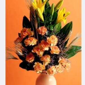 Yellow and peach carnation flower arrangement in a one-sided vase with lilies, available for delivery in Delhi.