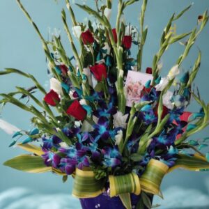 Front-facing bouquet of 10 blue orchids, 18 white gladioli, and 20 red roses in a ceramic vase, available for flower delivery in Delhi.